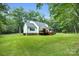 The sprawling green yard has trees and grass with views of the home and deck areas. Great for outdoor enjoyment at 316 Wade Hampton Dr, Matthews, NC 28104