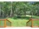 Beautiful backyard shot featuring a large trampoline with a safety net and steps leading down from an elevated deck at 316 Wade Hampton Dr, Matthews, NC 28104