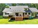 The home's backyard offers a deck with room for grilling, dark french doors, and views of the well-manicured yard at 316 Wade Hampton Dr, Matthews, NC 28104