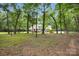 Beautiful shot of an enormous backyard with lush green grass and plenty of mature trees for privacy and shade at 316 Wade Hampton Dr, Matthews, NC 28104