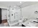 Clean bathroom featuring a marble shower with black hardware, stylish tile and double sinks at 316 Wade Hampton Dr, Matthews, NC 28104