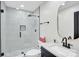 Beautiful bathroom with a glass walk-in shower, modern vanity, and decorative mirror at 316 Wade Hampton Dr, Matthews, NC 28104