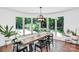 Bright dining room with modern lighting, rustic table, and large windows offering scenic outdoor views for Gathering gatherings at 316 Wade Hampton Dr, Matthews, NC 28104