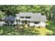Charming two-story home with white siding, a gray roof, a well-manicured lawn, and mature trees at 316 Wade Hampton Dr, Matthews, NC 28104
