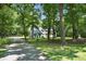 Nestled in a wooded area with a long driveway, this charming home features a spacious yard and mature trees at 316 Wade Hampton Dr, Matthews, NC 28104
