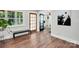 Inviting foyer featuring hardwood floors, a bench, natural light, and entrances to other rooms at 316 Wade Hampton Dr, Matthews, NC 28104