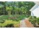Beautifully landscaped front yard with lush greenery and walking path at 316 Wade Hampton Dr, Matthews, NC 28104