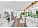 Open kitchen with white cabinets, stainless steel appliances, hardwood floors, and an easy transition to the dining area at 316 Wade Hampton Dr, Matthews, NC 28104