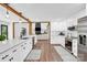 Stylish kitchen with white cabinets, a sleek island, stainless steel appliances, and an open view to the living room at 316 Wade Hampton Dr, Matthews, NC 28104