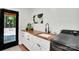 Bright laundry room featuring modern appliances and wood countertops at 316 Wade Hampton Dr, Matthews, NC 28104