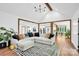 Open-concept living room with hardwood floors, stylish rug, and a seamless transition to the kitchen and dining area at 316 Wade Hampton Dr, Matthews, NC 28104
