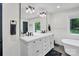 Bright main bathroom with double vanity, marble countertop, modern fixtures, and a freestanding tub at 316 Wade Hampton Dr, Matthews, NC 28104