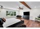 Spacious main bedroom boasts a decorative ceiling fan, large window, and stylish modern furniture at 316 Wade Hampton Dr, Matthews, NC 28104