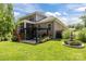 Brick home with a lush backyard featuring a covered porch, pergola, and decorative fountain at 322 Ethan Ln, Rock Hill, SC 29732