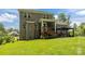 Expansive brick home backyard featuring a deck, patio, pergola and lush green lawn at 322 Ethan Ln, Rock Hill, SC 29732