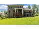 Spacious backyard showing a brick home, covered porch, deck, pergola, and manicured lawn at 322 Ethan Ln, Rock Hill, SC 29732