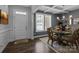 Dining room features paneled walls, a glass table, ornate chairs, decorative chandelier, and coffered ceiling at 322 Ethan Ln, Rock Hill, SC 29732