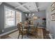 Dining room features a glass table, ornate chairs, decorative chandelier, large windows, and a coffered ceiling at 322 Ethan Ln, Rock Hill, SC 29732