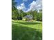 Traditional home featuring a lush green lawn, professional landscaping, and a charming brick facade at 322 Ethan Ln, Rock Hill, SC 29732