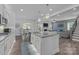 Open-concept kitchen featuring an island, stainless steel appliances, and a view into the dining and living areas at 322 Ethan Ln, Rock Hill, SC 29732