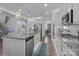 Bright kitchen features an island, stainless steel appliances, and granite countertops with modern fixtures at 322 Ethan Ln, Rock Hill, SC 29732