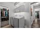Bright laundry room featuring modern appliances, ample cabinet storage, and a closet for added organization at 322 Ethan Ln, Rock Hill, SC 29732