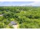 Aerial view shows a modern home nestled among trees, with the city skyline in the distance at 3304 Mar Vista Cir, Charlotte, NC 28209