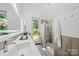 Bathroom features sleek modern design with a glass shower, large mirror, and natural light at 3304 Mar Vista Cir, Charlotte, NC 28209