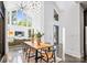 Open-concept dining area with modern lighting, a large table, and views into the living room at 3304 Mar Vista Cir, Charlotte, NC 28209