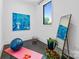 Bright exercise room with large window, yoga mat, mirror, and plants at 3304 Mar Vista Cir, Charlotte, NC 28209