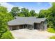 Wide view of modern home with a three-car garage, striking architecture, and gravel driveway at 3304 Mar Vista Cir, Charlotte, NC 28209