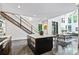 Open concept kitchen with large island, modern appliances, dining area, and adjacent staircase at 3304 Mar Vista Cir, Charlotte, NC 28209