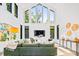 Bright living room with high ceilings, a green sofa, and large windows for ample light at 3304 Mar Vista Cir, Charlotte, NC 28209
