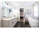 Bright bathroom featuring a soaking tub, double vanity, and walk-in closet entrance at 3741 9Th Street Ne Ct, Hickory, NC 28601
