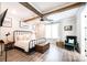 Bright bedroom featuring exposed wood beam ceiling, a ceiling fan, and wood-look flooring at 3741 9Th Street Ne Ct, Hickory, NC 28601