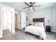 Bedroom boasting a wooden bed frame, a ceiling fan, and an ensuite bathroom entrance at 3741 9Th Street Ne Ct, Hickory, NC 28601