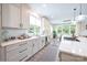 Bright kitchen with white cabinets, stainless steel appliances, and adjacent dining area with natural light at 3741 9Th Street Ne Ct, Hickory, NC 28601