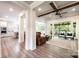 Bright living room with wooden beams, hardwood floors, and sliding glass doors to an outdoor patio at 3741 9Th Street Ne Ct, Hickory, NC 28601