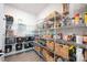 Organized walk-in pantry with white wire shelving and an assortment of baskets and food items at 3741 9Th Street Ne Ct, Hickory, NC 28601