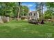 Large backyard featuring a fire pit, lush lawn, and mature trees, perfect for outdoor activities at 4000 Garfield Ct, Waxhaw, NC 28173