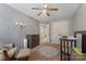 Well-lit Bedroom with a rocking chair, neutral walls, and a ceiling fan at 4000 Garfield Ct, Waxhaw, NC 28173