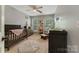 Well-lit Bedroom with two windows, a crib, and a changing table at 4000 Garfield Ct, Waxhaw, NC 28173