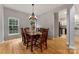 Bright dining room with hardwood floors and a wooden dining table with seating for six at 4000 Garfield Ct, Waxhaw, NC 28173