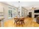 Bright dining area with large windows, hardwood floors, and a view of the backyard at 4000 Garfield Ct, Waxhaw, NC 28173