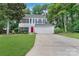 Charming two-story home with a well-manicured lawn, red door, and attached two car garage at 4000 Garfield Ct, Waxhaw, NC 28173