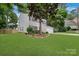 Charming two-story home features a well-manicured lawn, mature trees, and a red front door at 4000 Garfield Ct, Waxhaw, NC 28173