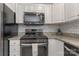 Modern kitchen with stainless steel appliances, granite countertops, and white subway tile backsplash at 4000 Garfield Ct, Waxhaw, NC 28173