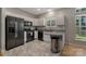 Updated kitchen featuring granite counters, stainless appliances, white cabinetry, and modern fixtures at 4000 Garfield Ct, Waxhaw, NC 28173