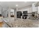 Kitchen with granite countertops, stainless steel appliances, and an island with a sink at 4000 Garfield Ct, Waxhaw, NC 28173