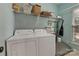 Functional laundry room with updated appliances and storage shelving at 4000 Garfield Ct, Waxhaw, NC 28173